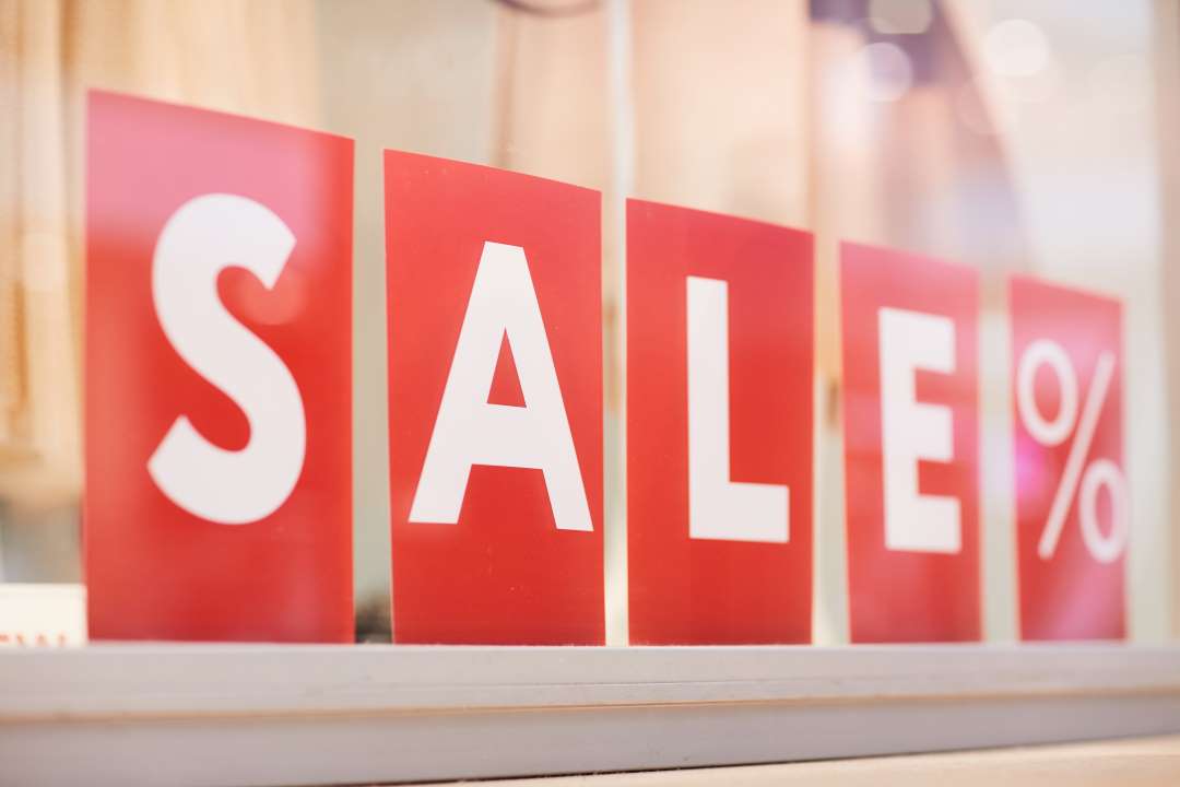 branding strategies, a sale sign outside a store
