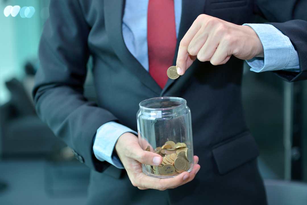 benefits of signage, a man putting coins in a jar
