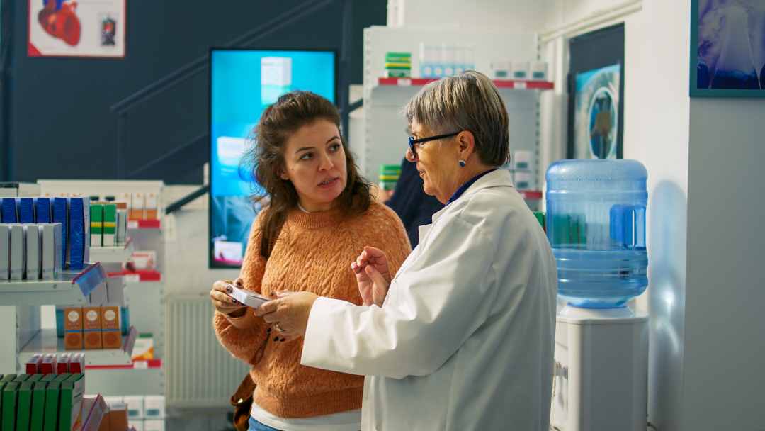 pop up display stands, a woman explaining a product to a customer