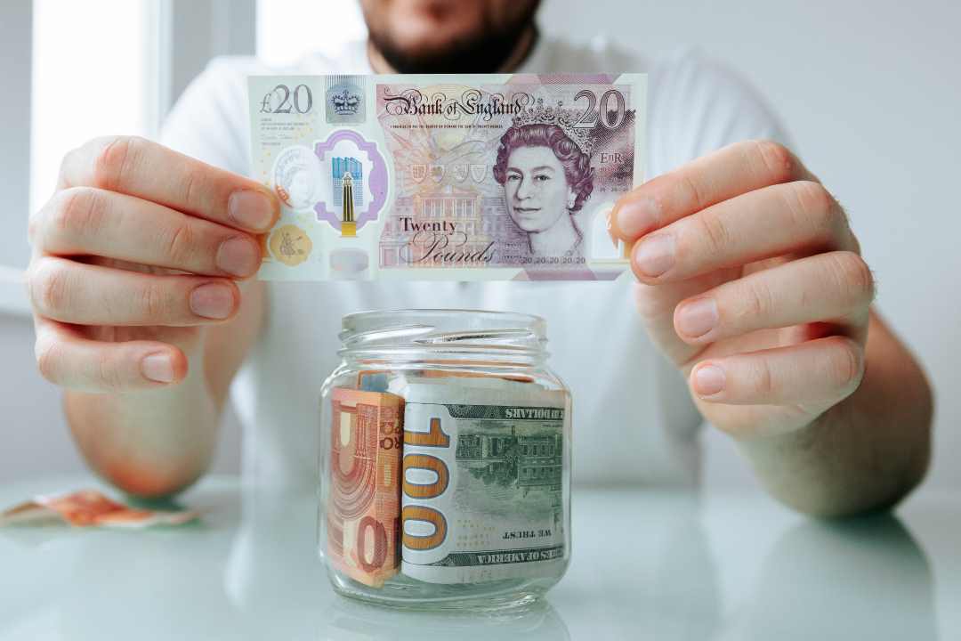pop up shop, a man holding a twenty-pound note