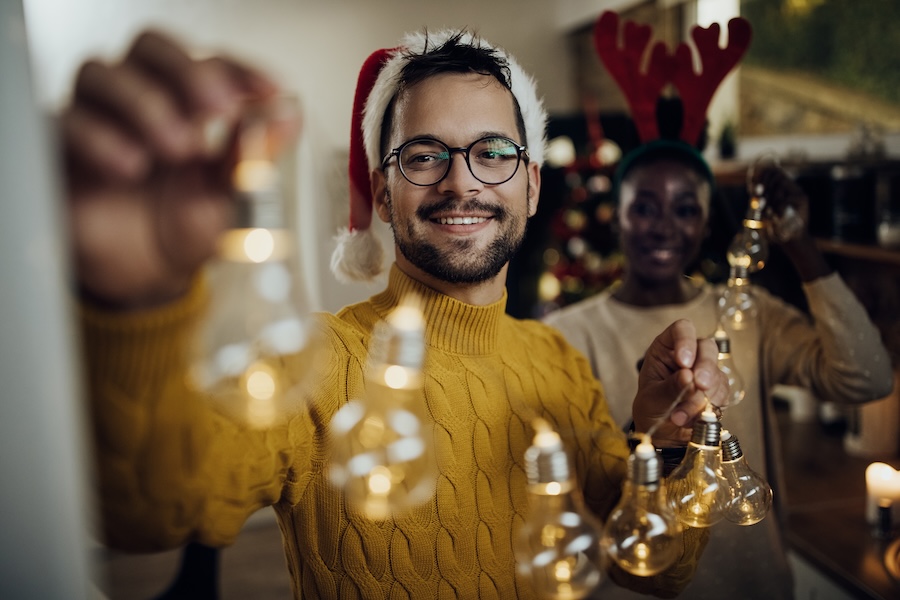 retail window display ideas, boy decorating the shop for festivities