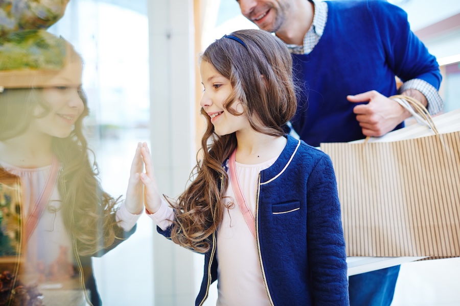 retail window display, a girl looking at the window display of retail store