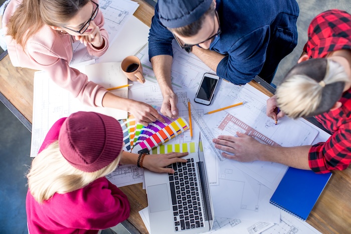 store signage, a team of designers sitting and deciding the layout and design for signage solutions
