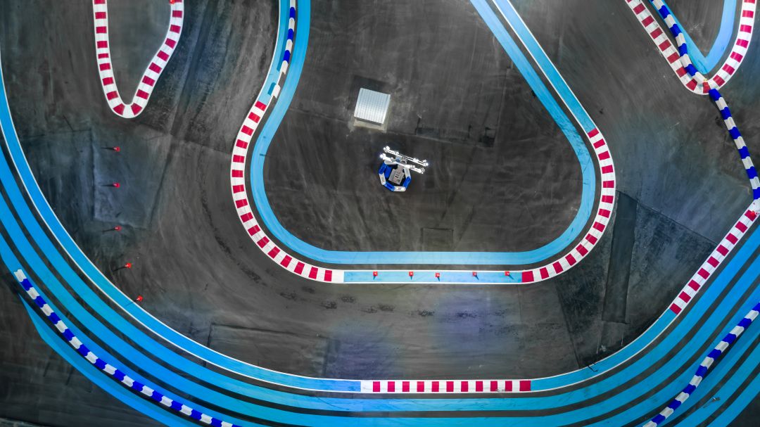 benefits of feather flags at sporting venues, aerial view of a go-kart race track