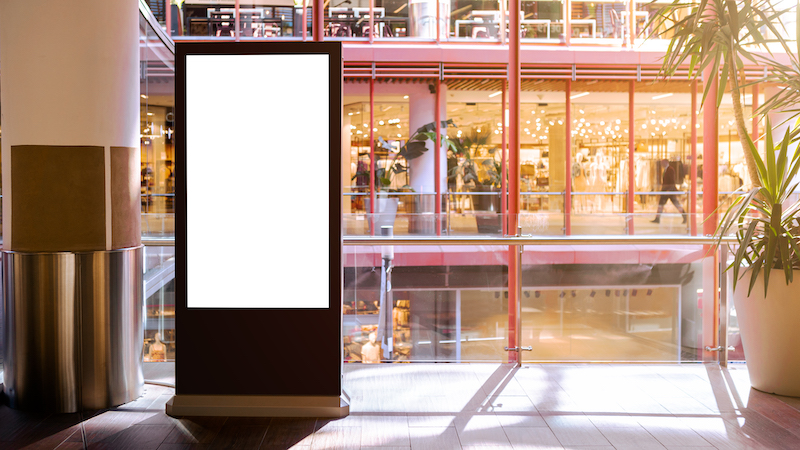 Indoor advertising vs outdoor advertising, digital ad in a mall.