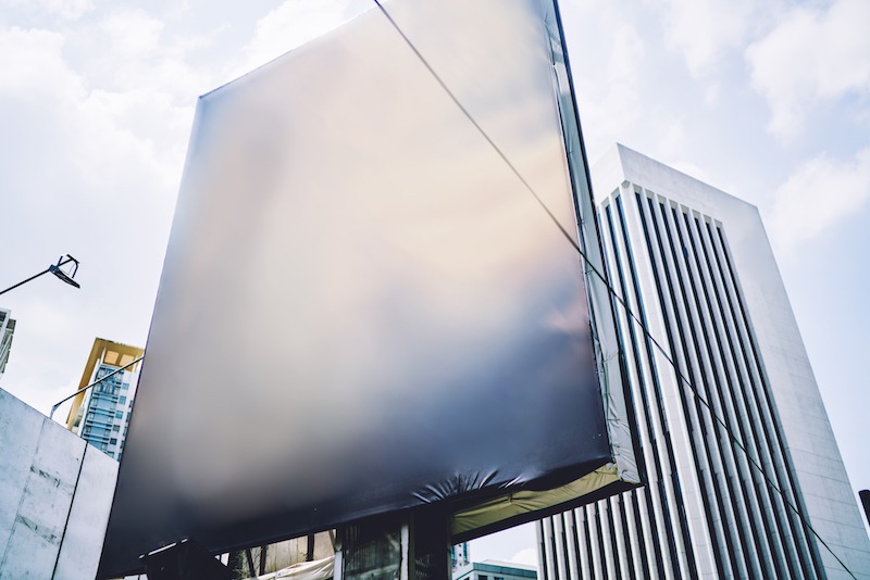 Benefits of sustainable flag materials, large banner near buildings.