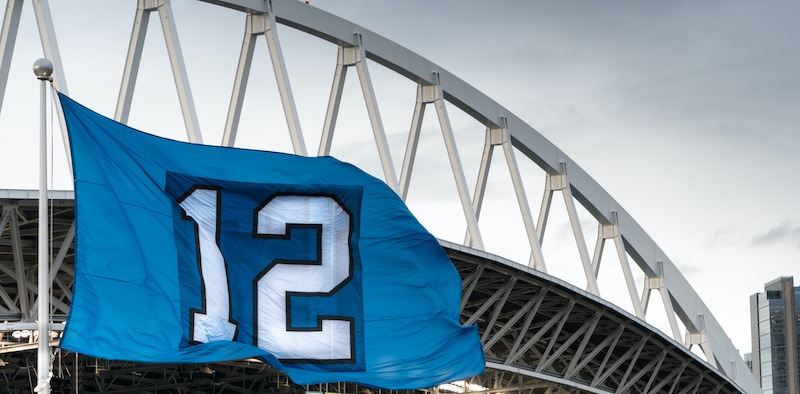Stadium sponsorship branding, large blue flag at sports stadium.