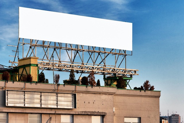 Construction Site Advertising, large blank hoarding board on a building roof.