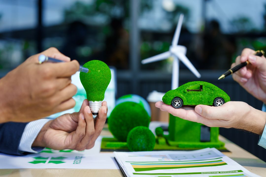 case studies of sustainable branding in the automotive sector, a meeting at an office desk regarding sustainable automotive marketing