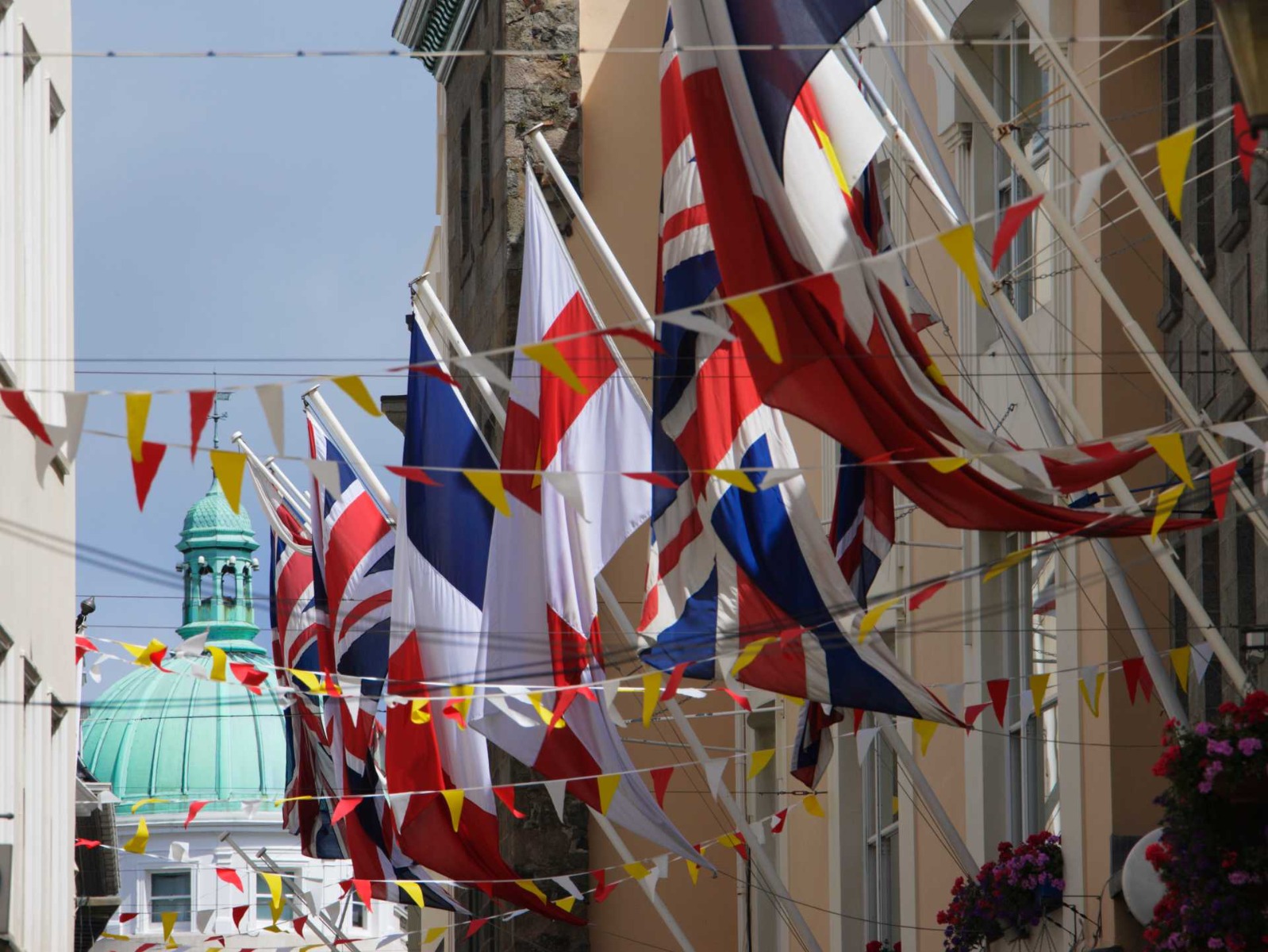 comparing feather flags and angled flags, A mix of different national flags on display.