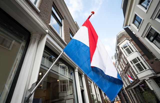 Flagpole planning permission, Dutch flag mounted on building side.