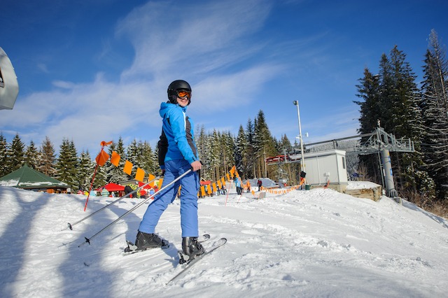 Ski Resort Marketing, female skier on a ski slope with bunting.