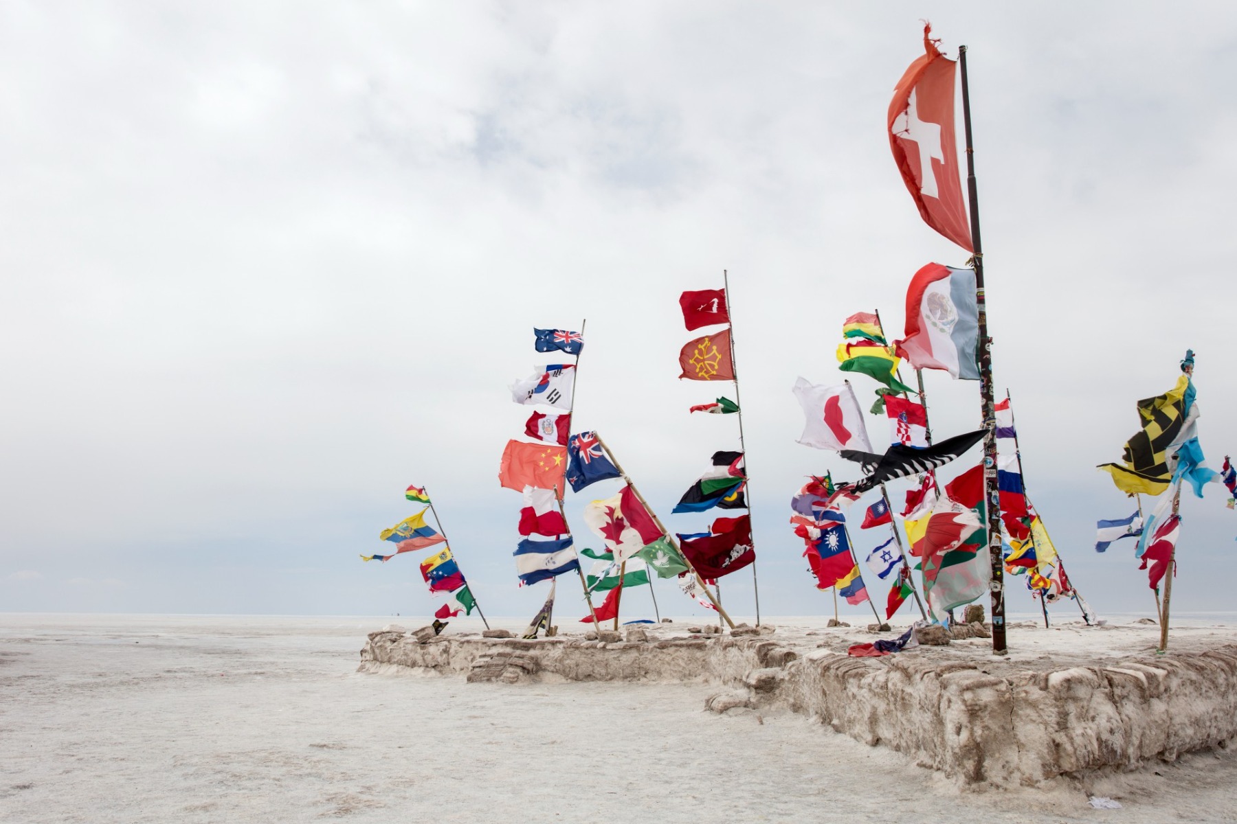 flags-vs-windsock; multiple flags placed in a sandy area