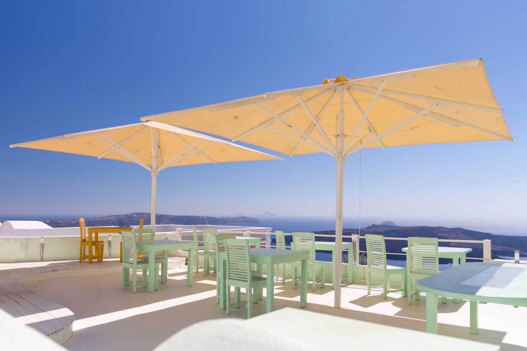 how to maintain a parasol, The outdoor seating area of a restaurant overlooking a lake.