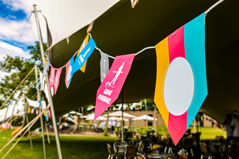 Flag positioning, colourful bunting at an outdoor event.