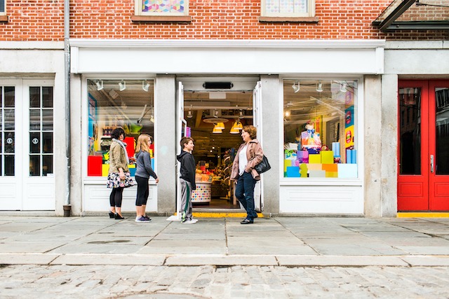 Tell a Brand Story, people standing outside a shop with colourful displays.