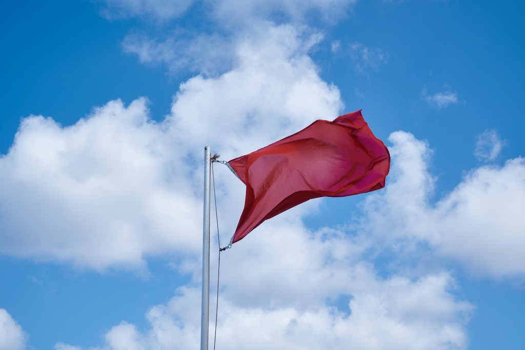 Flag Size Guide, red flag on a pole.