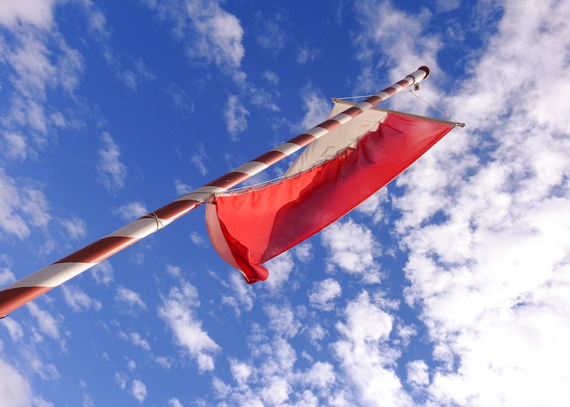Promoting Housing Estates, red and white flag on a pole.