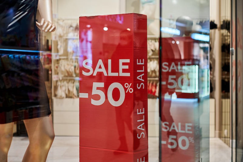 Franchise brand identity, sale banners inside store.