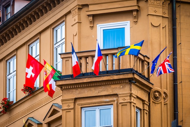 Flag colours in branding, building entrance with multiple country flags.