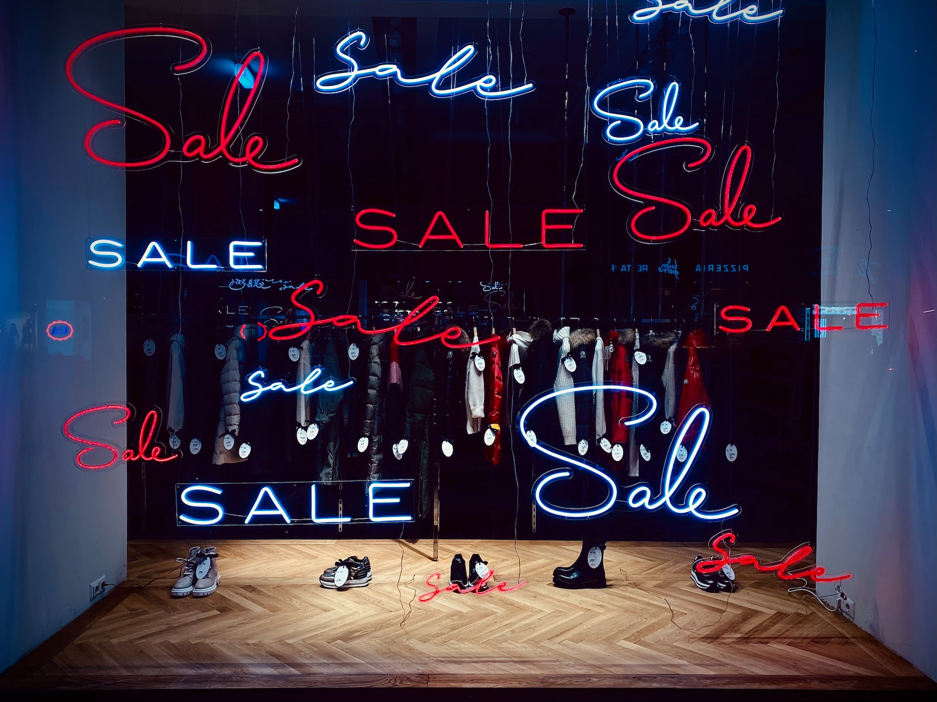 POP display tips, multiple lit-up sale signs on a store display window.