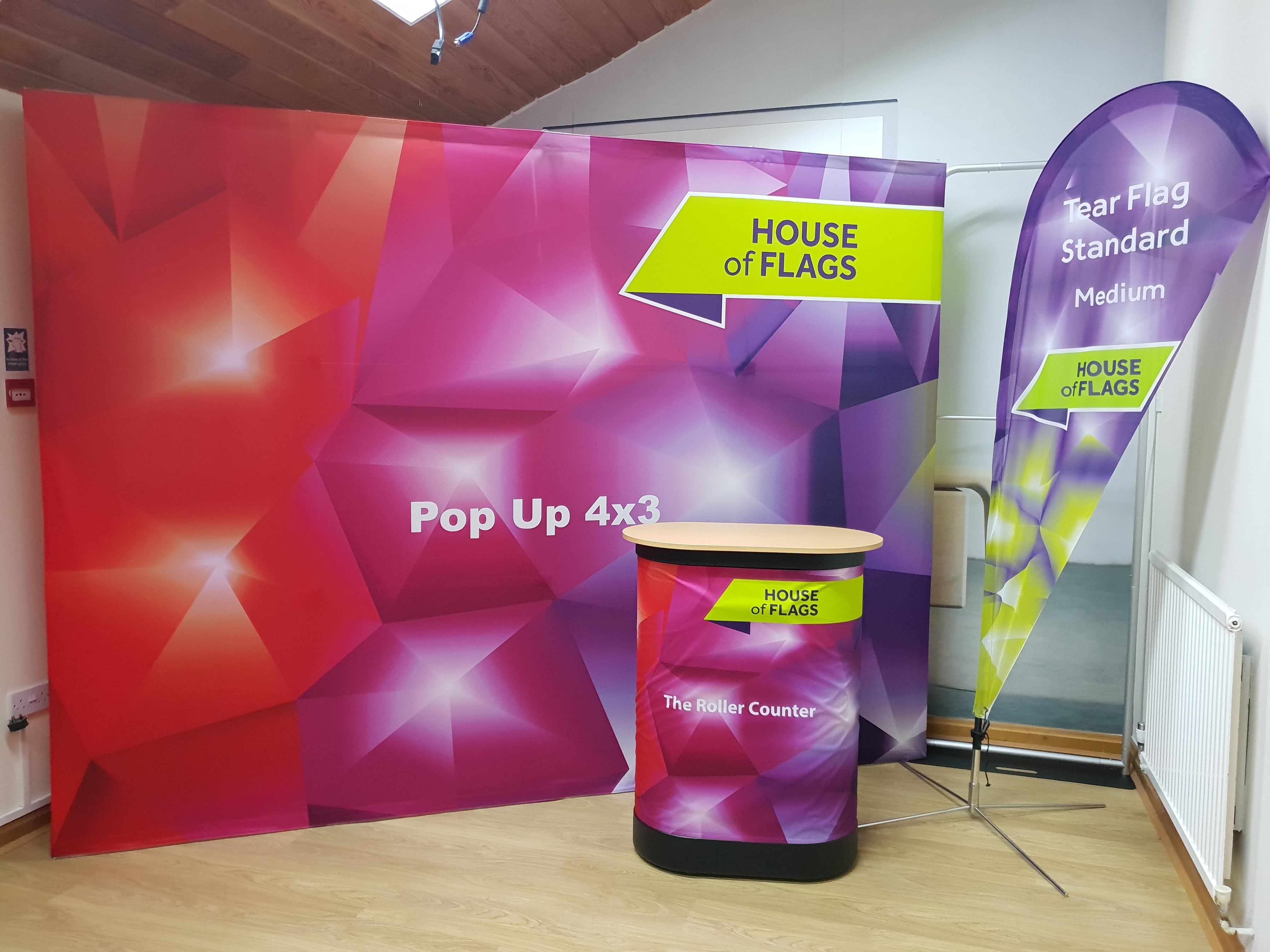 New product launch ideas, House of Flags pop up stand, roller counter, and teardrop flag.