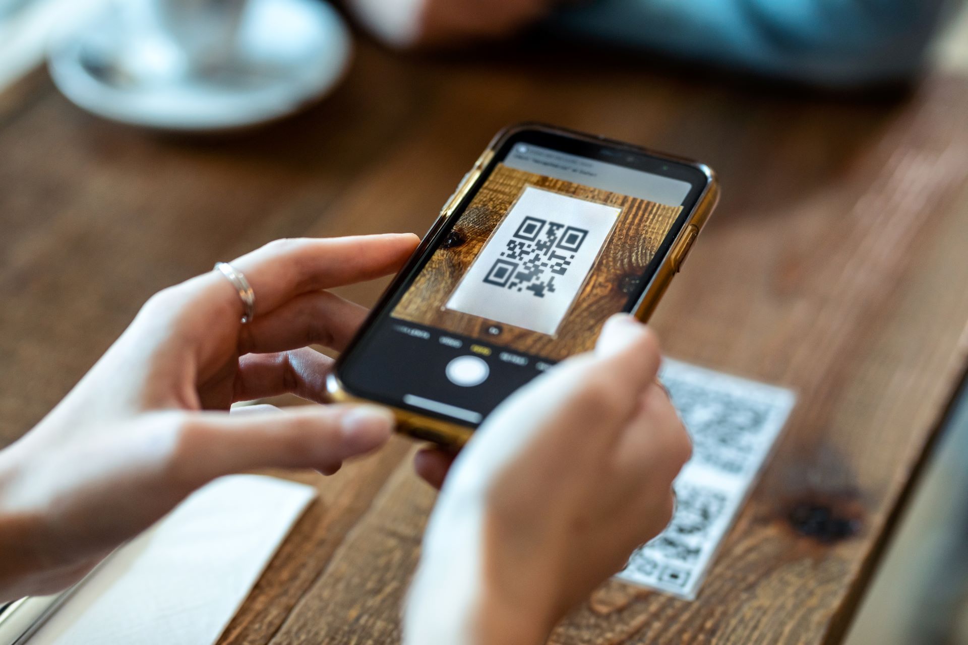 custom banners, a lady scanning a QR code to attain special offers and coupons.