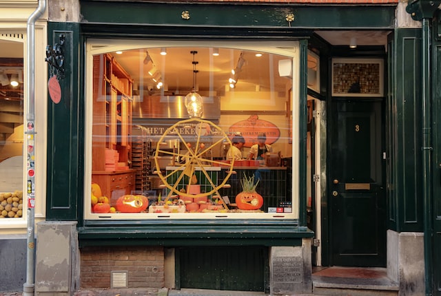 Halloween retail display, a Halloween-themed window display with pumpkins and a tiny ferris wheel.