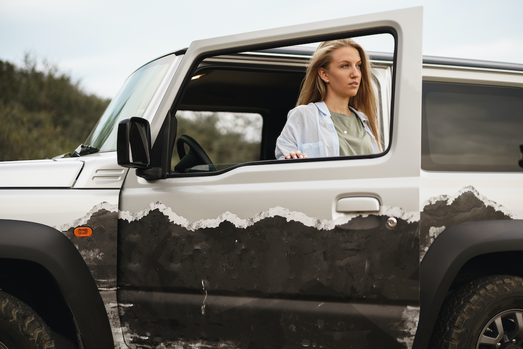 Vehicle Graphics for Business, woman standing near jeep with graphics.