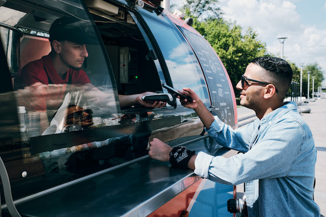 Vehicle Graphics for Business, man buying food from a food truck.